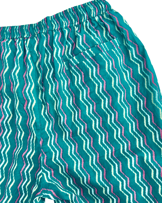 PADMA Cotton Shorts featuring a colorful neon wave pattern and elastic waistband for comfort and style.