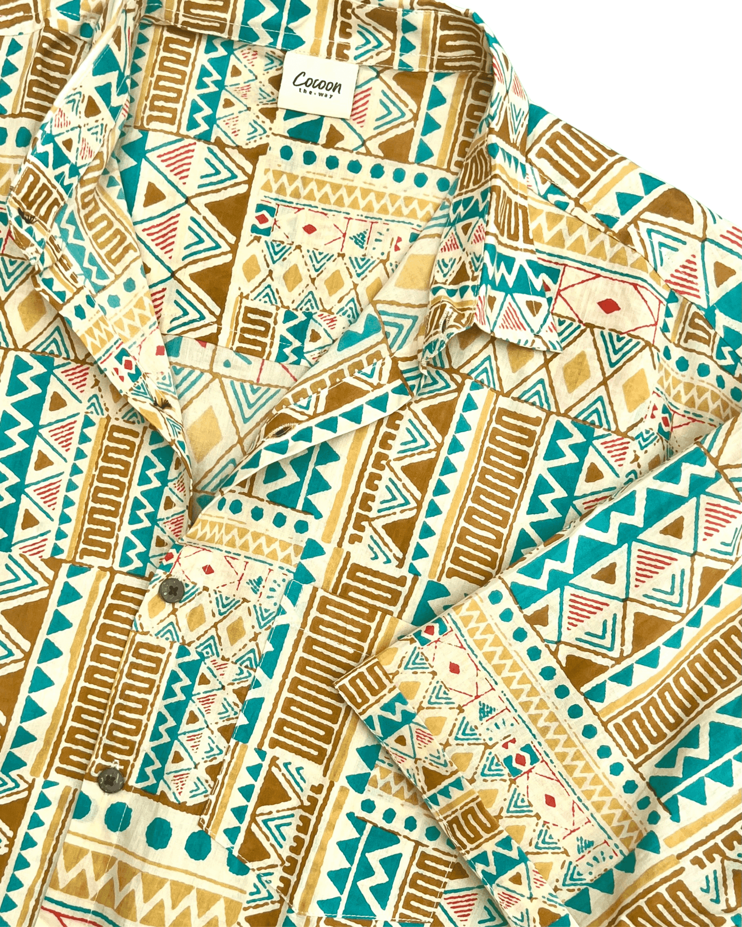 PADMA Short Sleeve Shirt featuring a vibrant yellow and blue tribal pattern, crafted from breathable cotton for comfort.