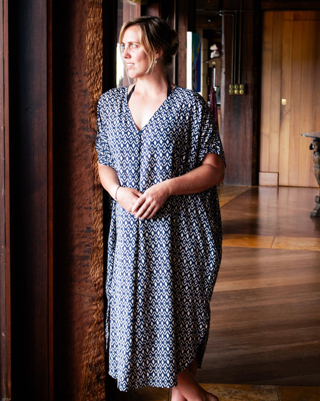 Model wearing the GLORIA Dress, a flowing kaftan silhouette in Royal Ikat print, showcasing elegance and versatility.