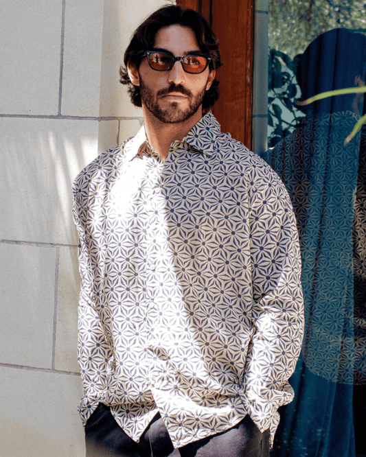 Man wearing SAIRA Long Sleeve Shirt with geometric pattern, standing outdoors with sunglasses — The Cocoon Way