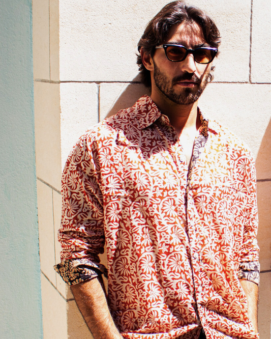 Model wearing SAIRA Long Sleeve Shirt Sevilla with a floral pattern, showcasing style and comfort in natural cotton.