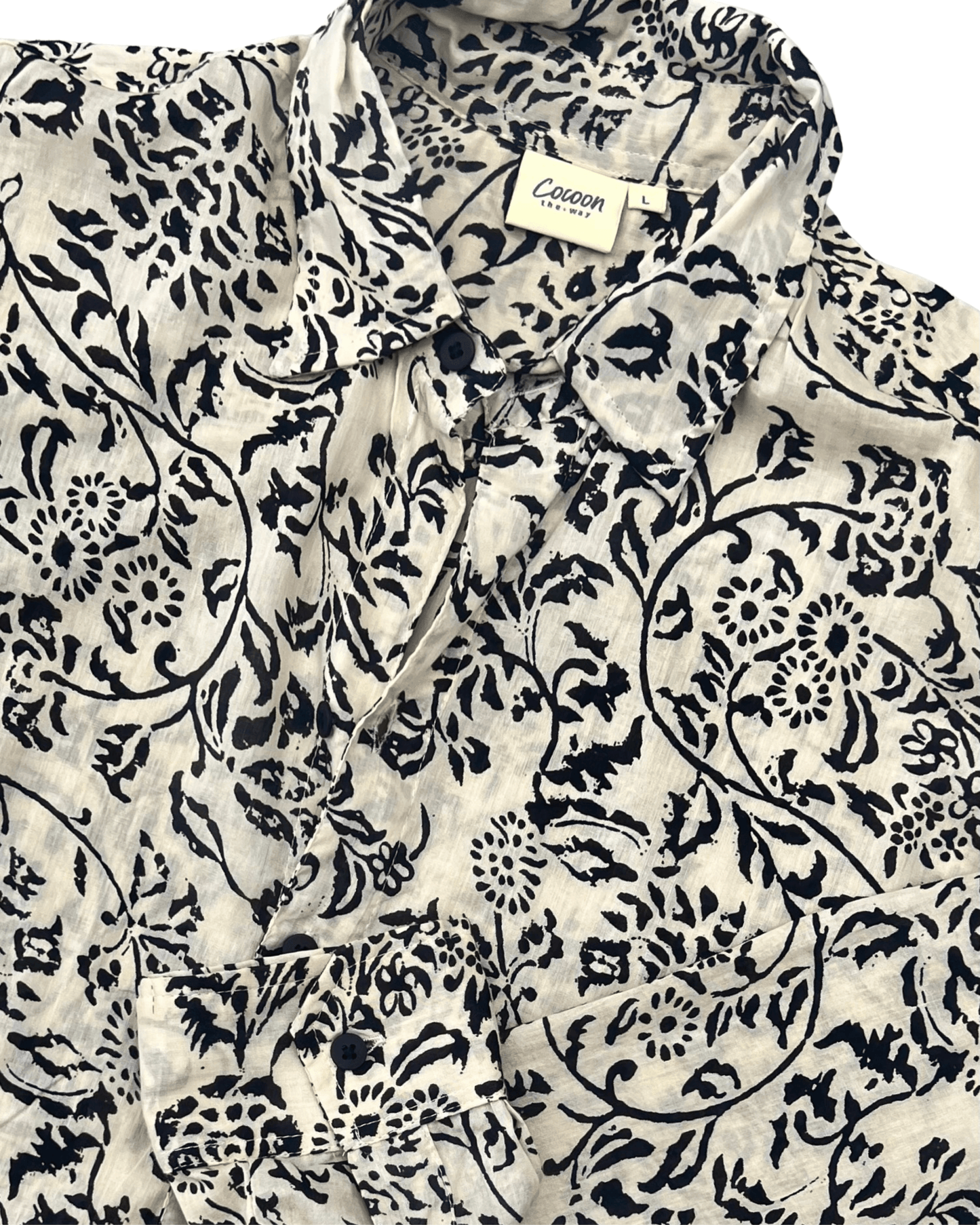 SAIRA Long Sleeve Shirt in cream with black floral pattern, showcasing stylish design and breathable cotton fabric — The Cocoon Way