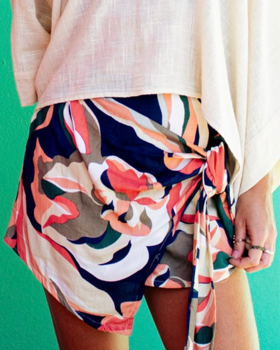 Woman wearing VERA Skort Fusion with colorful floral patterns and adjustable side knot for a stylish look — The Cocoon Way