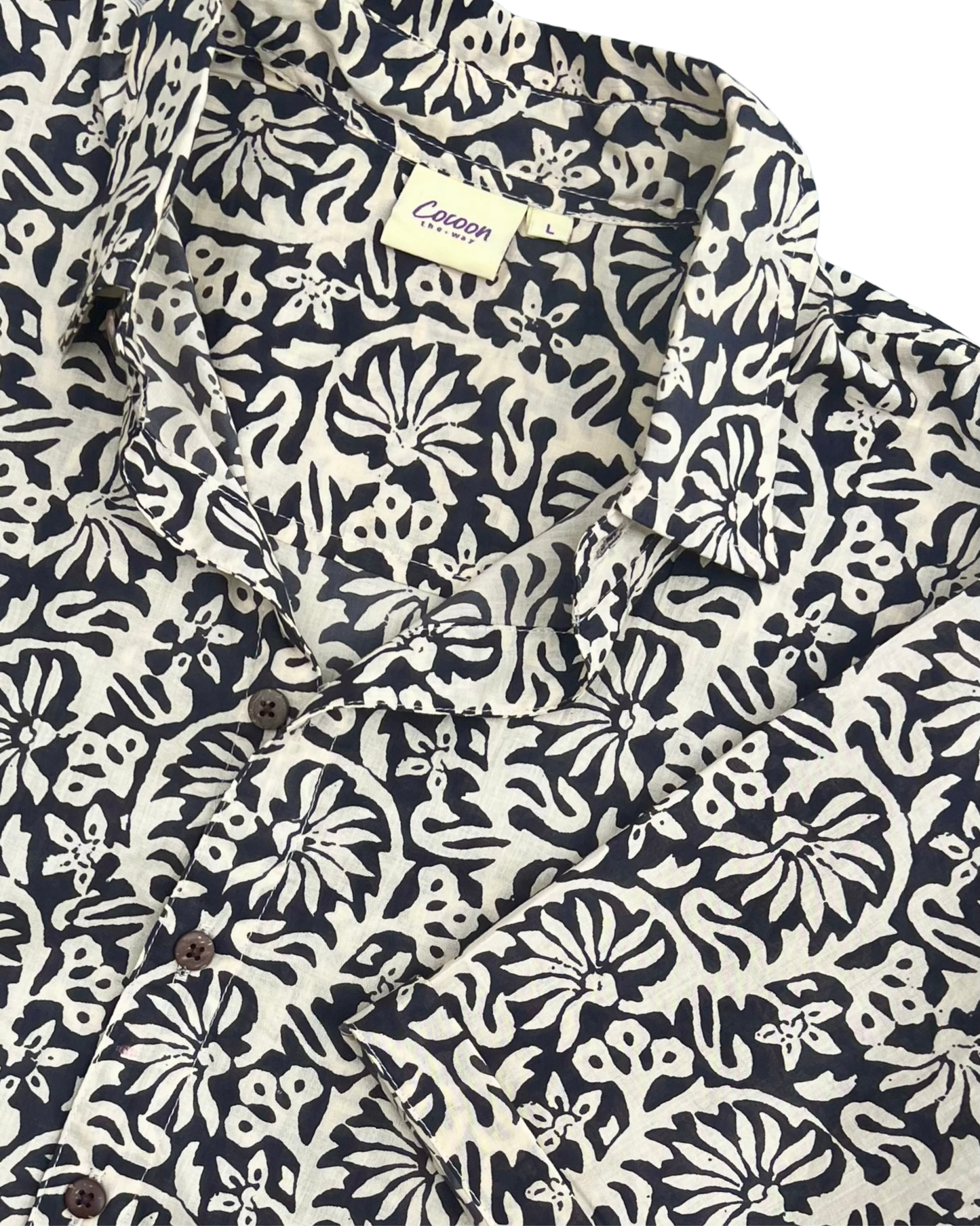 SAIRA Short Sleeve Shirt in a floral pattern with buttons and a collar, showcasing breathable cotton design by The Cocoon Way.