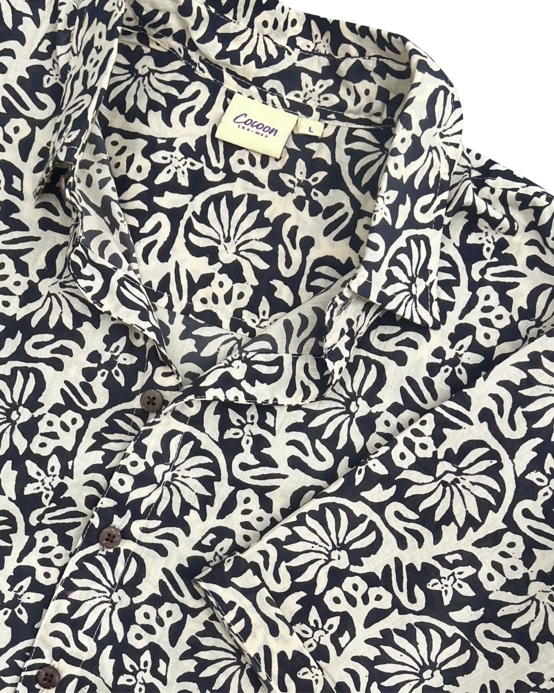 SAIRA Short Sleeve Shirt in a floral pattern with buttons and a collar, showcasing breathable cotton design by The Cocoon Way.