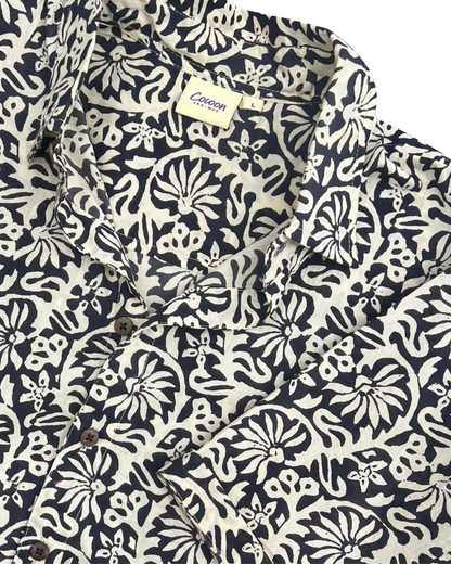 SAIRA Short Sleeve Shirt in a floral pattern with buttons and a collar, showcasing breathable cotton design by The Cocoon Way.