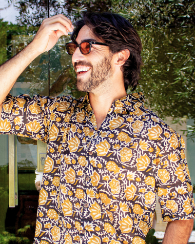 SAIRA Short Sleeve Shirt worn by a smiling man outdoors, showcasing floral design and relaxed fit — The Cocoon Way