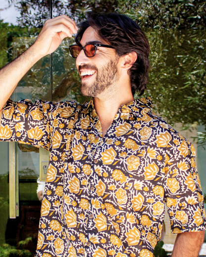 SAIRA Short Sleeve Shirt worn by a smiling man outdoors, showcasing floral design and relaxed fit — The Cocoon Way