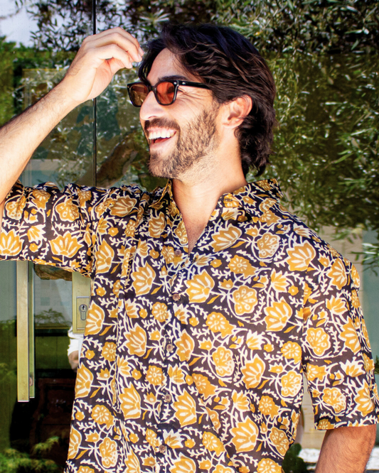 SAIRA Short Sleeve Shirt worn by a smiling man outdoors, showcasing floral design and relaxed fit — The Cocoon Way