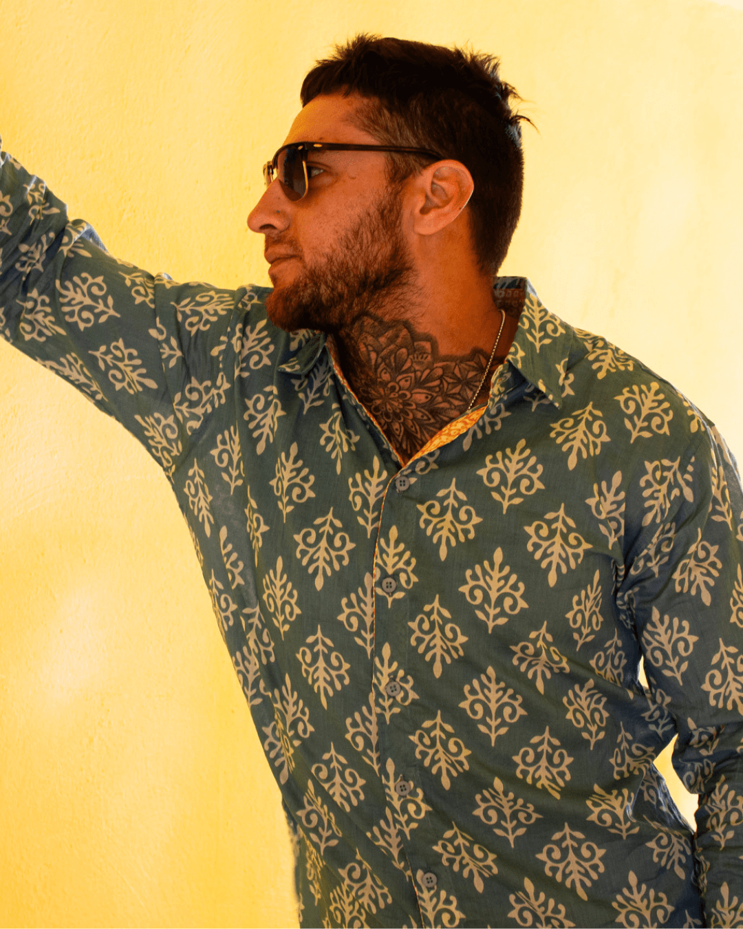 SAIRA Long Sleeve Shirt worn by a man, featuring a patterned design and sunglasses against a yellow background.