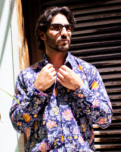 Model wearing PADMA Long Sleeve Shirt with floral pattern, showcasing elegance and comfort in outdoor setting.