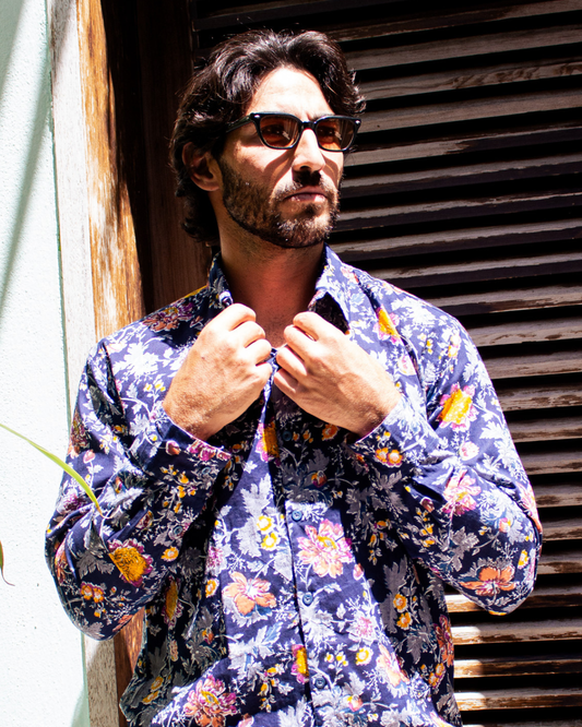 Model wearing PADMA Long Sleeve Shirt with floral pattern, showcasing elegance and comfort in outdoor setting.