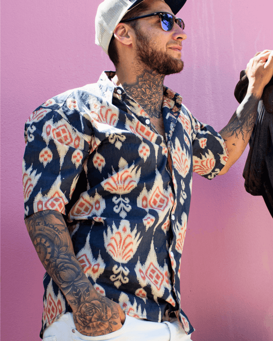 PADMA Short Sleeve Shirt Blue Ikat worn by model, showcasing casual style and unique ikat print against a pink background — The Cocoon Way