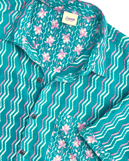 Close-up of the PADMA Short Sleeve Shirt featuring a vibrant Neon Wave pattern and soft Cambric cotton fabric — The Cocoon Way