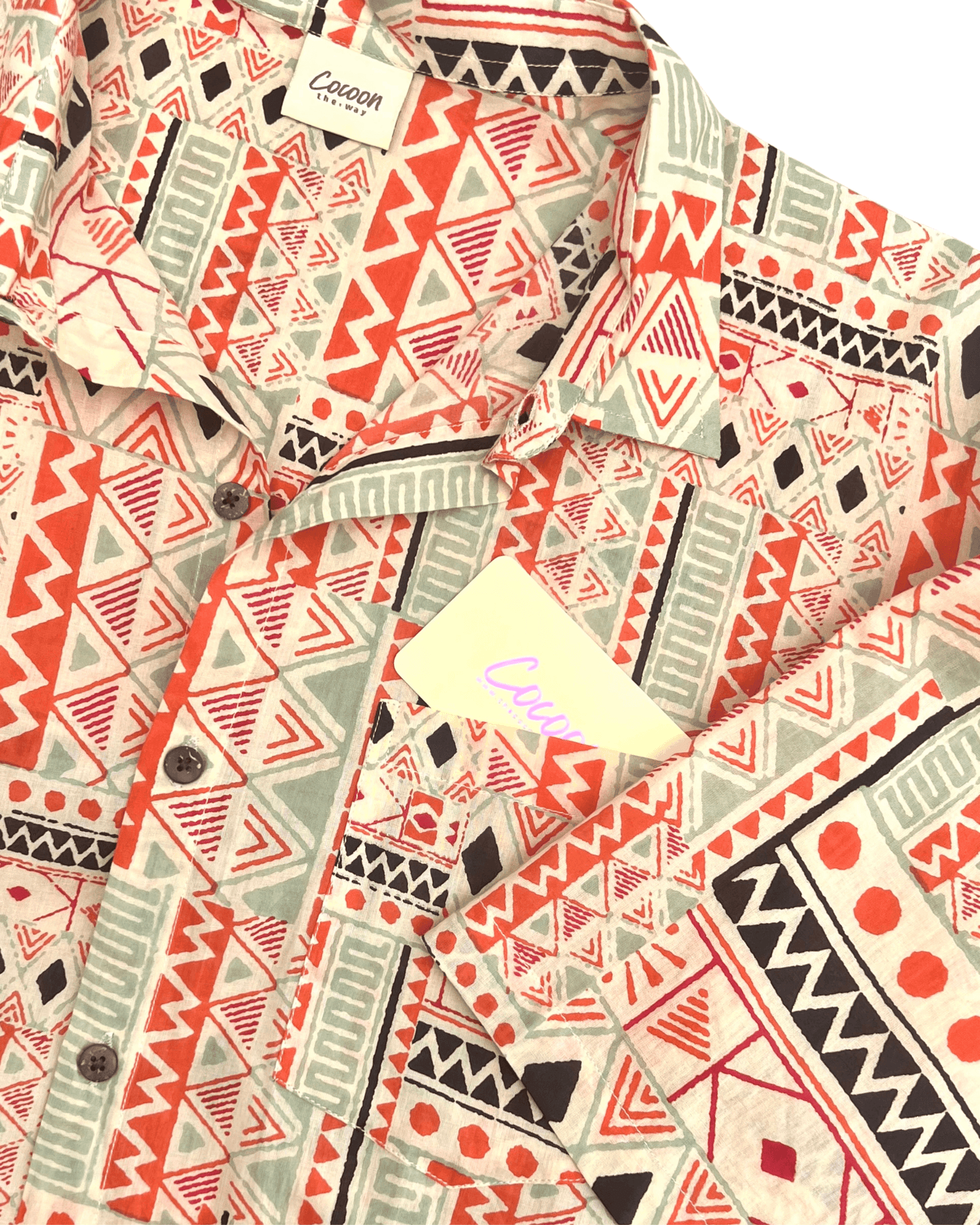 PADMA Short Sleeve Shirt in Orange Tribe pattern featuring vibrant geometric designs and soft Cambric cotton fabric.