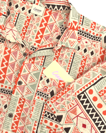 PADMA Short Sleeve Shirt in Orange Tribe pattern featuring vibrant geometric designs and soft Cambric cotton fabric.
