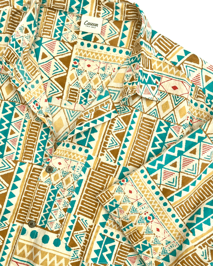 PADMA Short Sleeve Shirt featuring a vibrant yellow and blue tribal pattern, crafted from breathable cotton for comfort.