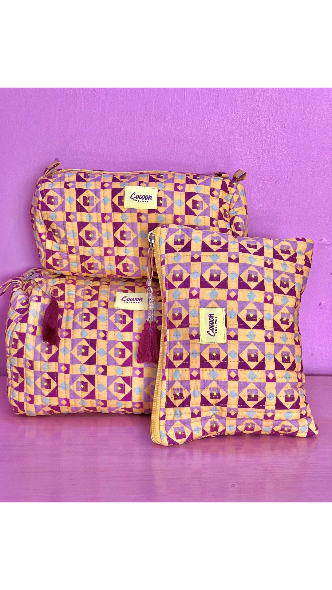 The Cocoon Way Niwas large quilted cotton pouches in yellow and purple geometric print with tassel zip closures.