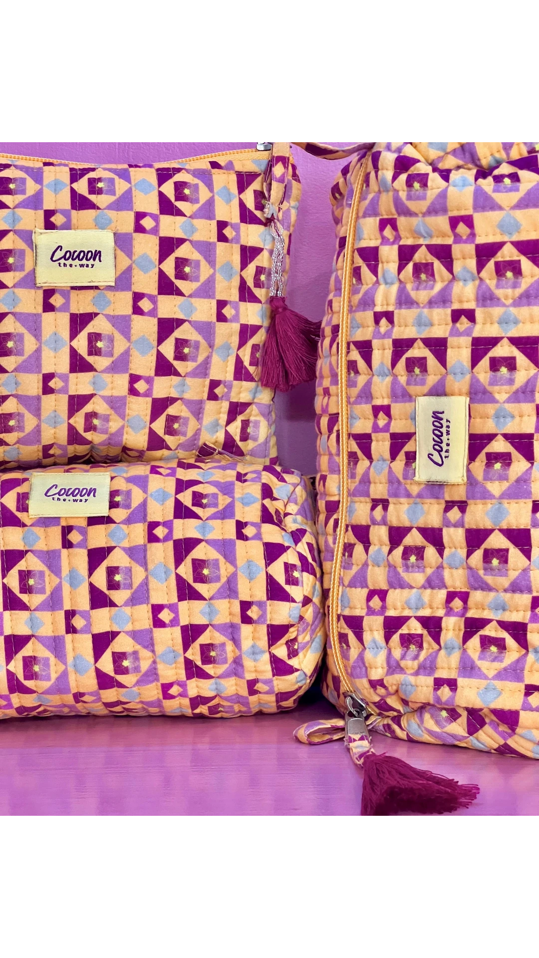 The Cocoon Way Niwas large quilted cotton pouches in a purple and orange geometric print with tassel zip details.